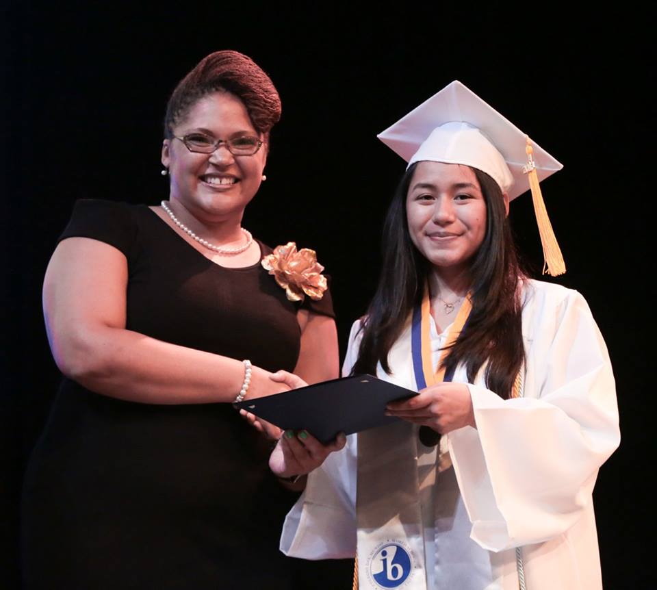CEO Charleita Richardson smiling with a graduating student.